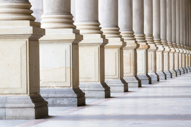 Row of classical Columns with copy space, Czech Republic Closeup bases row of marble columns. Symbols of integrity, stability, and trustworthiness. Closeup row of classical marble columns. Detail of Mlynska colonnade Karlovy Vary Czech republic establish 1881, this is the biggest colonnade in Karlovy Vary. Full frame horizontal composition with copy space