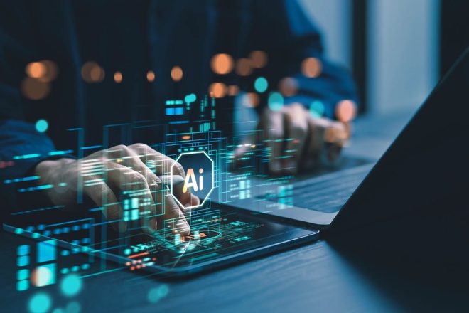 Image of a person typing on a laptop with an AI overlay. Hero image for the article AI's Economic Impact and the Role of Dividend Growers in Investor Portfolios