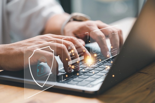 Protecting Your Investment Account: A Guide to Spotting and Avoiding Scams article image of someone typing on a laptop