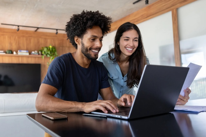 Man and woman work together on a laptop