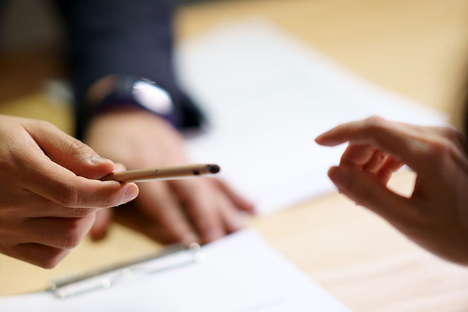 A person grabbing a pencil. width=