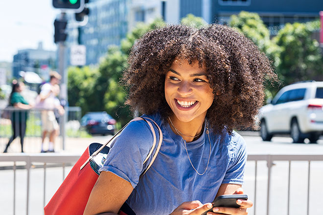 Woman smiling and holding a phone