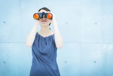 Woman with binoculars looking ahead