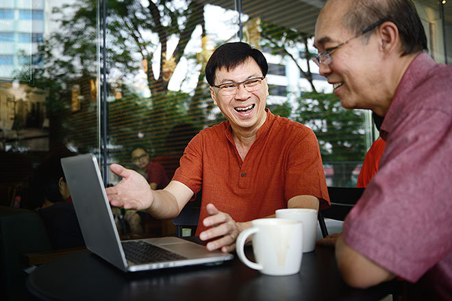 Two men looking at a laptop computer