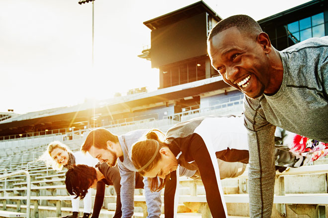 Group of people doing pushups