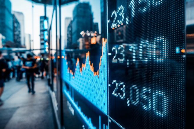 digital stock ticker on busy city street