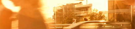 A city at sunset decorated with people going about their evening.