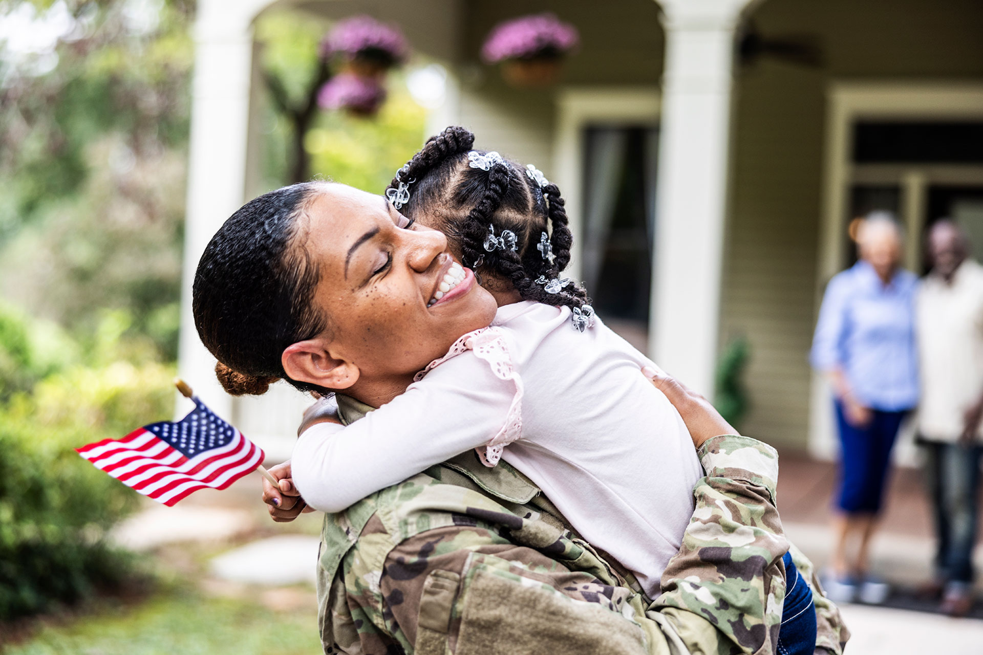 Woman veteran hugs her child.